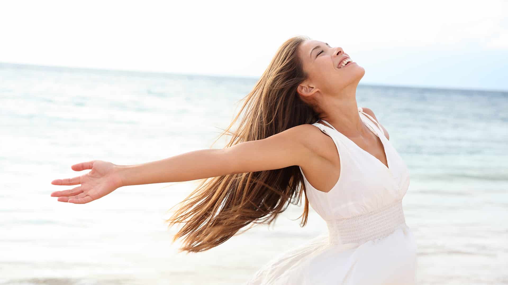 Woman relaxing at beach enjoying summer freedom